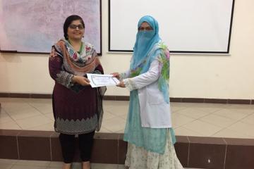 Participant receiving Certificate from Dr. Zilli Huma.